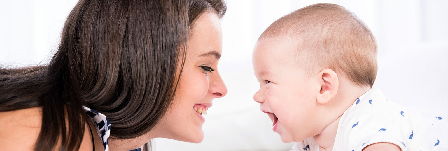 Baby and mother smiling