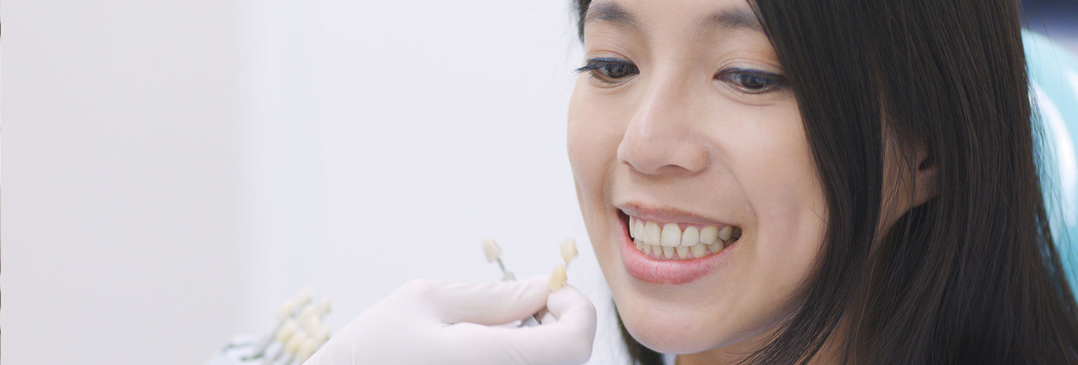 Beautiful woman smiling after Porcelain Crowns