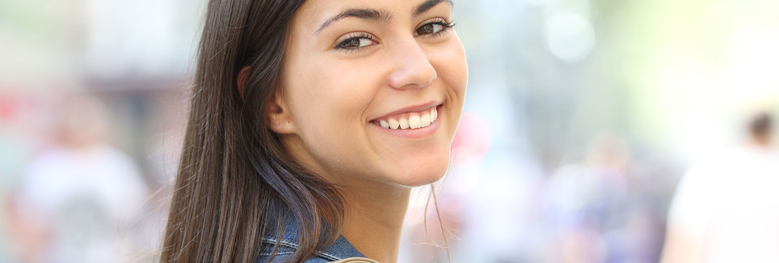 Beautiful woman smiling after Orthodontic Treatment Phases